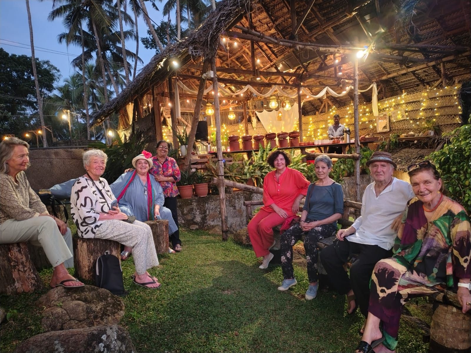 Guests together at the lantern lit pavilion in the evening